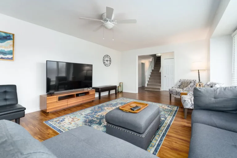 The family room is well-equipped with a futon, lots of seating and a smart tv, connected to the dining room .