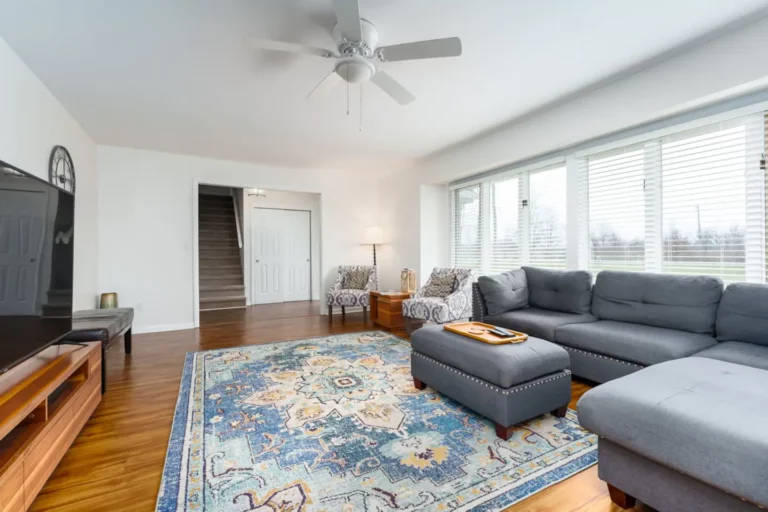 The family room is well-equipped with a futon, lots of seating and a smart tv, connected to the dining room.