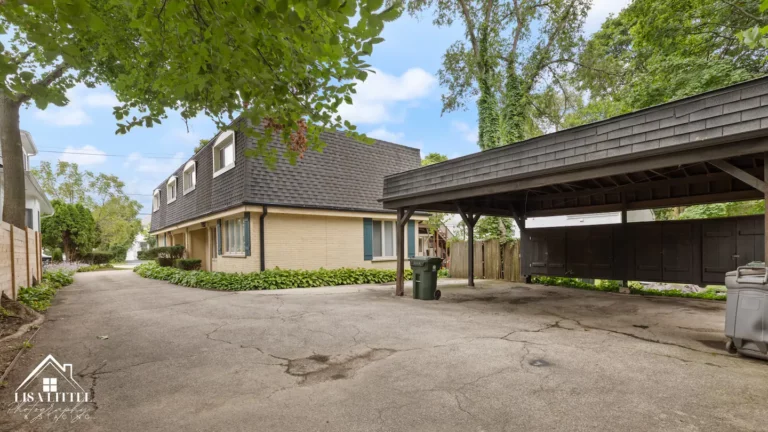 The carport and open parking space are just steps from the front door.