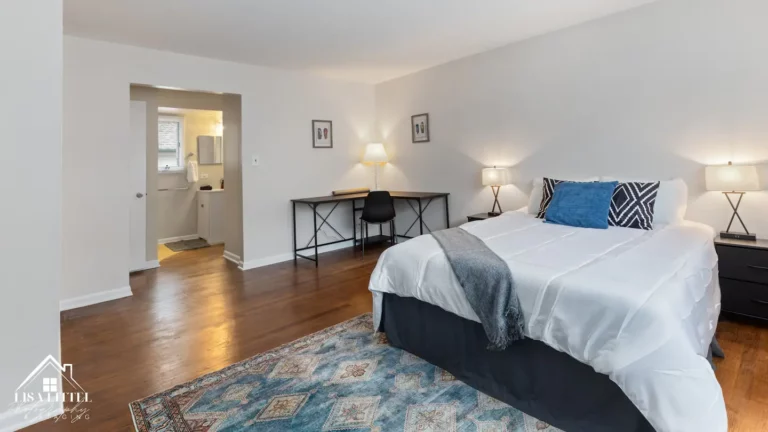 The huge primary bedroom includes a luxurious queen mattress, an l-shaped desk and tons of storage. The ensuite bath is connected.
