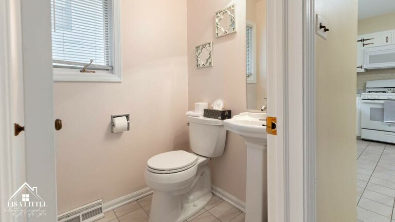 The powder room is conveniently located on the first floor, adjacent to the kitchen and family room.